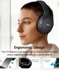 Person wearing Hybrid Noise Cancelling Wireless Over Ear Headphones With 90 Hour Battery Life Bluetooth Six Point Zero Foldable Design.