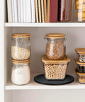 Slick 10 Inch Heavy Duty Swivel Base With A Slim Zero Point Eight Inch Profile And Rock Solid One Hundred Pound Support For Smooth 360 Degree Spin On Any Desk Or Counter For Monitors Plants And Everyday Tech Gear displayed in a pantry with storage jars.