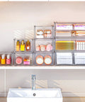 Super Slick Acrylic Stackable Drawer Set Of Six Pack For Vanity And Bathroom Desk Organization Modular Units stacked with toiletries.