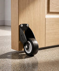 ElaraBerry 12 Pcs 2'' Anti-sag Gate Support Wheels, Black Caster Roller attached to wooden door corner.