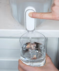 Person using 18 Cup Home Water Filter Dispenser That Really Cleans Water Removing Bacteria And Parasites Reducing Microplastics And Chemicals