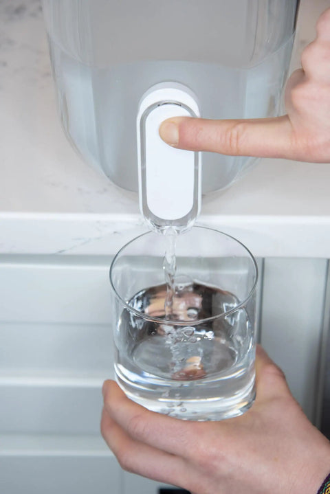 Person using 18 Cup Home Water Filter Dispenser That Really Cleans Water Removing Bacteria And Parasites Reducing Microplastics And Chemicals