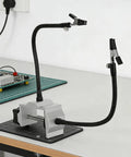 Helping Hands Soldering Table Clamp Dual Arm Third Hand Tool on a workspace with PCB and grid mat.