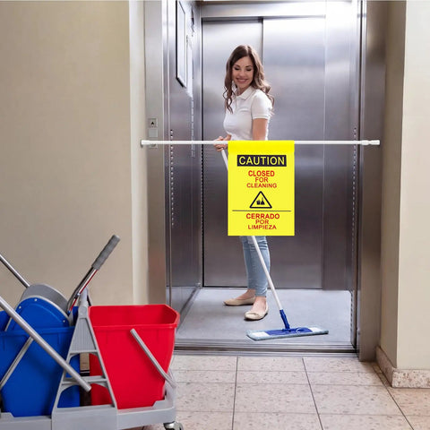 Double Sided Restroom Closed For Cleaning Sign With Telescopic Stand And High Viz Yellow Panel Bilingual English Spanish Floor Board in use.