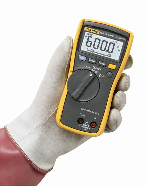Gloved hand holding True RMS Utility Multimeter For DIY And Pros Measures AC DC Voltage, Resistance, Capacitance, Continuity And Diode Tests.