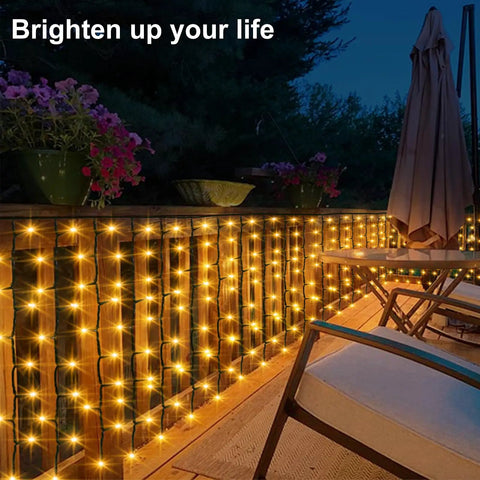 Solar Curtain Lights Outdoor 200 LED Set decorating a patio fence at night