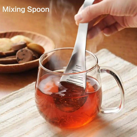 Ginger Grater Spoon And Lime Zester With Garlic Press And Wasabi Grinder used to mix tea in glass mug on table