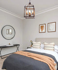 Industrial Pendant Light With Classic Black Metal Cage For Farmhouse And Modern Homes in a bedroom setting above a bed