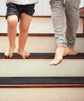 Adults and child walking on non slip carpet stair treads set of 14 black 6x30 with pre applied adhesive for indoor steps for safety