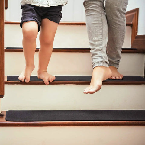 Adults and child walking on non slip carpet stair treads set of 14 black 6x30 with pre applied adhesive for indoor steps for safety