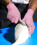 Cut Resistant Gloves Level 5 Food Grade For Kitchen Safety Medium Pink HPPE Knitted Fibers in use while filleting fish