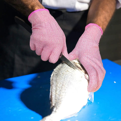 Cut Resistant Gloves Level 5 Food Grade For Kitchen Safety Medium Pink HPPE Knitted Fibers in use while filleting fish