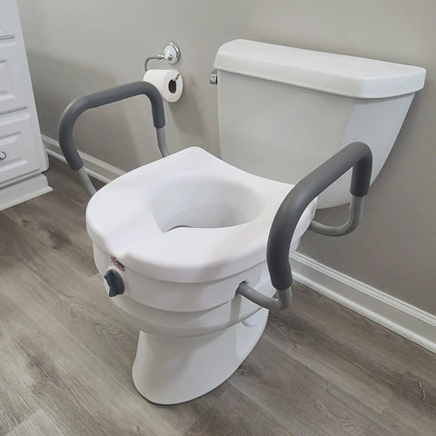 Raised Toilet Seat With Handles Five Inch Riser With Arms For Seniors Safe Stable Comfort Up To 300 Lb Capacity E Z Lock Base Handicap Elevated Toilet Seat on a toilet in bathroom setting.