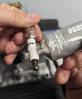 Permatex dielectric tune-up grease, 3 oz, shown being applied to a spark plug boot terminal.