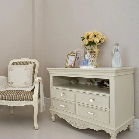 Slick Vintage White Ceramic Cabinet Knob Set Four Piece Single Hole Drawer Pulls Premium Zinc Alloy Base on a cream-colored dresser.