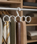 Slick Closet Organizer And Scarf Hanger That Crushes Your Morning Clutter With Wide Loops For Quick Belt Tie And Hijab Storage. White organizer with rings holds scarves and belts on a closet pole.