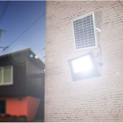 JUDYSSY Solar Flood Lights 60W Solar Outdoor Patio Lighting mounted on wall with solar panel and bright LED light.