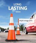 Eight Pack 28 Inch Orange Traffic Cones With Black Weighted Base Reflective Collar PVC Safety Cone For Traffic Control On Construction Sites Road Work Parking Lots Driveways And Events displayed near a red car
