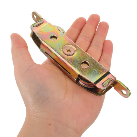 Premium Heavy Duty Sliding Door Wheel Pulley Replacement Kit Featuring A Smooth Gliding Double Iron Roller Design held in hand for size reference.
