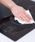 Hand cleaning a glass stovetop with Heavy Duty Cleaning Wipes 260 Count Bulk Pack With Dual Texture For Hands And Surfaces Remove Paint Adhesives Oils Grease And Dirt Grime Busting Safe On Skin With Aloe Vera And Vitamin E