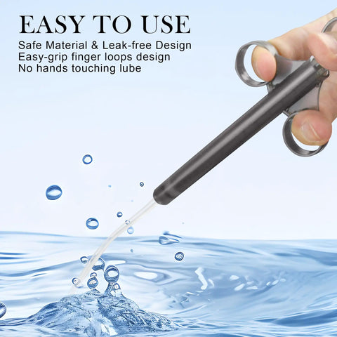 6.5 Inch Lube Shooter With Air Proof Silicone Cap Reusable Lube Tube Applicator 10ml Precise Scale held in hand over water splash