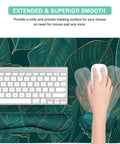Ergonomic Large Mouse Pad And Keyboard Wrist Rest Dope Desk Pad For Keyboard And Mouse 4 In 1 Extended Gaming Desk Mat With Wrist Support For Home Office Study Green Leaves, top view with keyboard and hand using mouse on a leaf design.