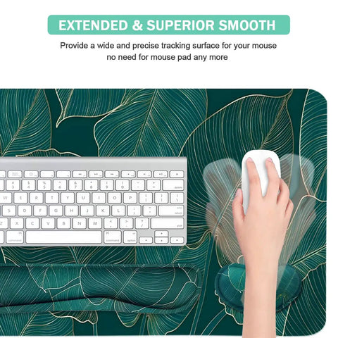 Ergonomic Large Mouse Pad And Keyboard Wrist Rest Dope Desk Pad For Keyboard And Mouse 4 In 1 Extended Gaming Desk Mat With Wrist Support For Home Office Study Green Leaves, top view with keyboard and hand using mouse on a leaf design.