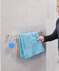 Man holding towel on 2 Pack Adjustable Single Bath Towel Bars 16 To 27 Point 6 Inches Chrome Finished Stainless Steel Towel Holder Hanger