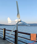 1000W 48V Horizontal Wind Turbine Kit With 3 Blades And MPPT Charge Controller installed by waterfront for off grid power generation.