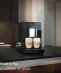 Kick Back And Sip Perfection With This Ultra Quiet Fully Automatic Bean To Cup Coffee And Espresso Machine featuring two coffee cups brewed simultaneously.
