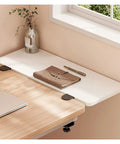 Fold Down Wall Mounted Desk Extender Tray And Side Table That Expands Your Space with notebook, pen, and plant decor
