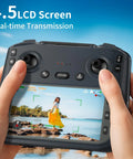 Hands holding remote with 4.5 inch LCD screen showing live video from 4K GPS Drone With Real Time FPV 5GHz Quad Copter Auto Return Home Follow Me Triple Obstacle Avoidance Beginner Friendly SD Card Slot Long Flight Time Under 249g.