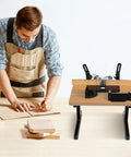 Solid Build Router Table With Heavy Duty Stand And Adjustable Fence Premium Mdf Workbench used by a man sketching on wood in workshop.