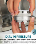 Hands holding 53mm Coffee Distributor And Tamper For 54mm Portafilters With Adjustable Depth And Dual Head Leveler near espresso machine