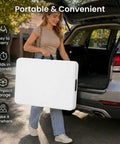 Person carrying a Six Foot Folding Table For Indoor And Outdoor Use, Lightweight Portable Rectangular White Plastic Dining Table With Steel Legs