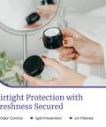 Sleek Black Glass Storage Jar With Airtight Seal Keeps Your Goodies Fresh And Secure in hands with lid off showcasing contents.