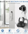 Total Game Changer For Your Washroom Matte Black 6 Pack Suction Hooks With Heavy Duty Grip To Hang Tough Towels And Gear No Drilling Mess Free Setup On Glass Smooth Tile Surfaces in bathroom with towel and weight.