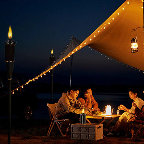 Torch Replacement Canisters For Bamboo Lanterns, Refillable Outdoor Torches illuminating a nighttime garden party under a canopy.