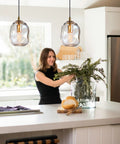 Dope Clear Art Glass Pendant Lights 2 Pack For Kitchen Island And Dining Room Table with brass hardware in modern kitchen.