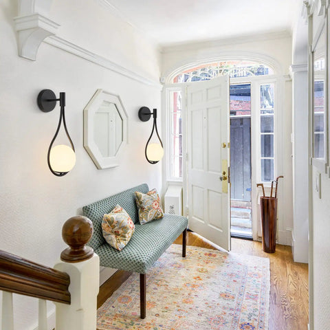 Modern Globe Wall Sconce Set Of 2 Black Glass Drop Lights illuminating a hallway with frosted glass ball and minimalist water drop design