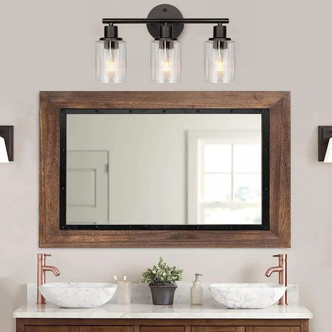 Clear Lipless Glass Lamp Shade Cylindrical Light Cover With Fitter Opening Replacement For Chandeliers And Sleek Bathroom Vanity Lights And Pendants Pack Of 2 Ideal For Edison Bulbs And Modern Fixtures mounted above wooden mirror in bathroom.