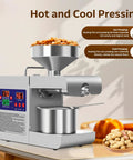 Rkazes 820W Automatic Oil Press Machine Hot And Cold Seed Extractor For Home Use Easy Clean Kitchen Gadget High Output Nut Peanut Olive Oil Maker with peanuts in a bowl.