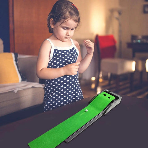 Child playing with Indoor Mini Golf Mat With Auto Return System For Home And Backyard Practice in living room