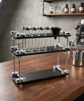 Keep Your Morning Brew On Lock With This Sleek Single Dose Coffee Bean Storage Rack Featuring Eight Smooth Glass Jars Precision Dosing Funnels And True One Way Seals For Every Chill Home Brewer on a wooden counter
