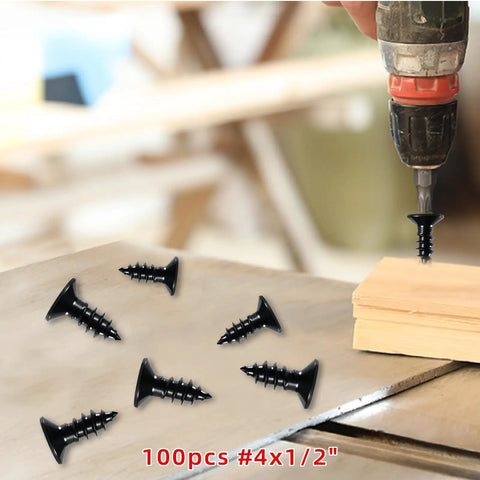 Premium Black Stainless Steel Wood Screws Featuring Flat Phillips Heads Rust Resistant Finish Smooth Driving Action Ideal For Plywood And Softwoods 100 Pack Size 4 By Half Inch laid out on wood surface with a drill.