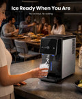 Smooth Crew Countertop Nugget Ice Maker With Tap On Dispenser dispensing chewable ice into a glass, shown on a kitchen countertop.