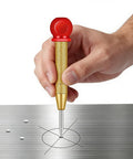 Hand holding Top Shelf Handheld Automatic Center Punch With Secure Cap For Crisp Metal And Woodworking Layouts Built For Stress Free Diy Builds And Rock Solid Pinpoint Marking on metal surface.
