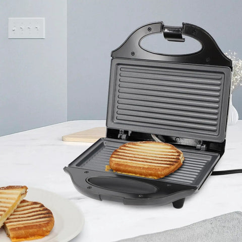 Dude, this killer Compact 750W Electric Nonstick Sandwich Maker And Panini Press Grill cooking a sandwich on its plates.