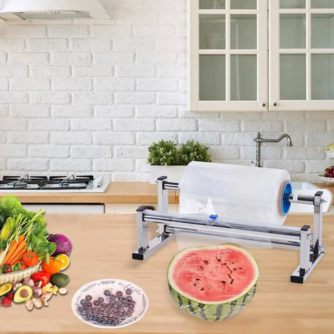 Stainless Steel Tabletop Stretch Film Dispenser With Film Slide Cutter surrounded by vegetables and fruit on a kitchen counter