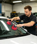 Top Shelf Heavy Duty Metal Glass Vacuum Lifter With Flexible Lip Suction Cup Handle Designed For Curved Car Windshields And Large Ceramic Tile Plates No Sweat Operation being used by a man on a car windshield.